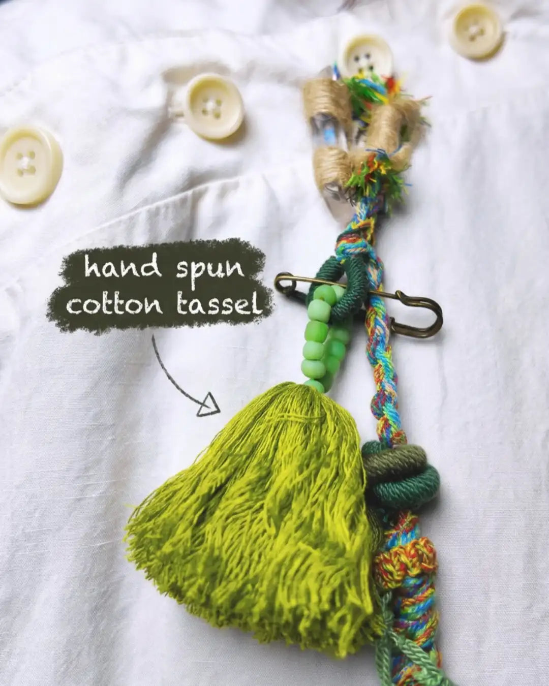 Hand spun cotton tassel detail from The Tree of Life #04 — close-up of the lime green hand spun cotton tassel with glass beads on the lower tassel drop.