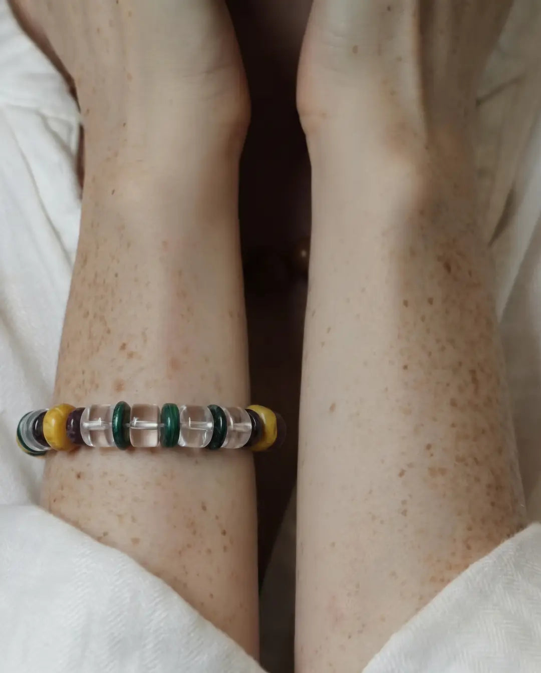 Close worn view of The Vow #26 across both wrists, showing its clear quartz bead sequence