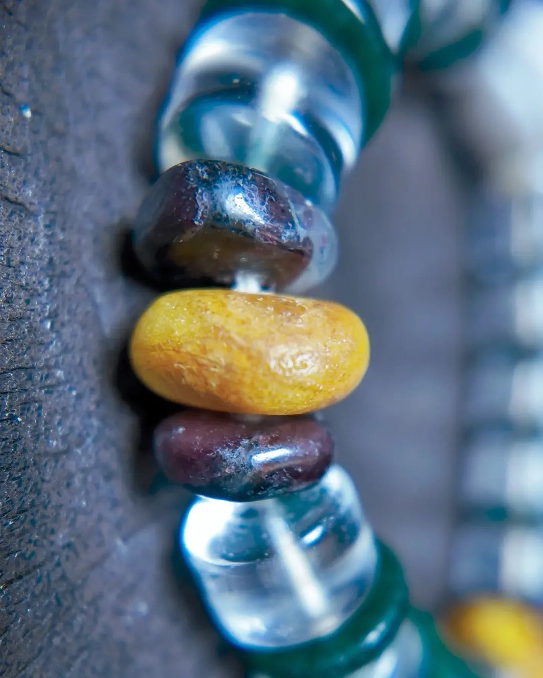 Macro of yellow amber, red and translucent square beads in The Vow #26