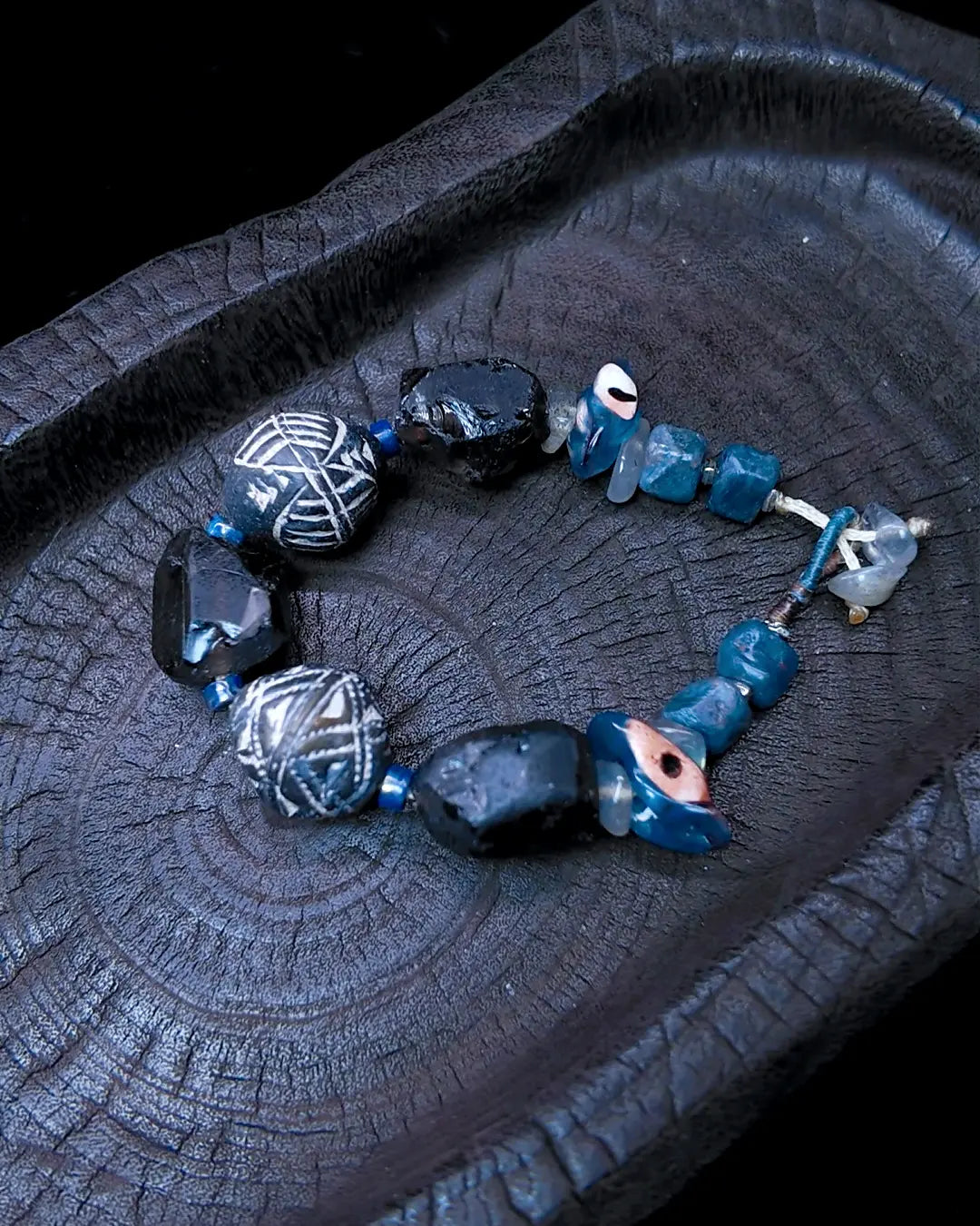 The Ancestor #31 smoky quartz and Mali clay grounding bracelet, closure detail showing labradorite toggle and sliding-knot finish