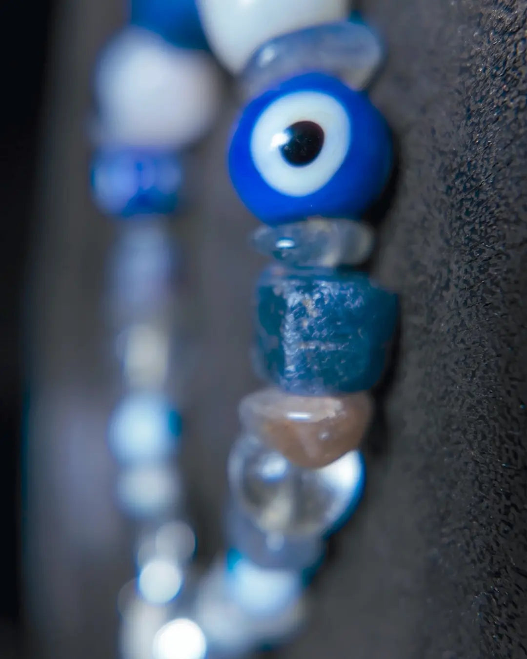 The Augur #33 lapis lazuli and blue moonstone vision bracelet, detail view 6 — showing raw sapphire, labradorite, clear quartz, and evil eye glass accents
