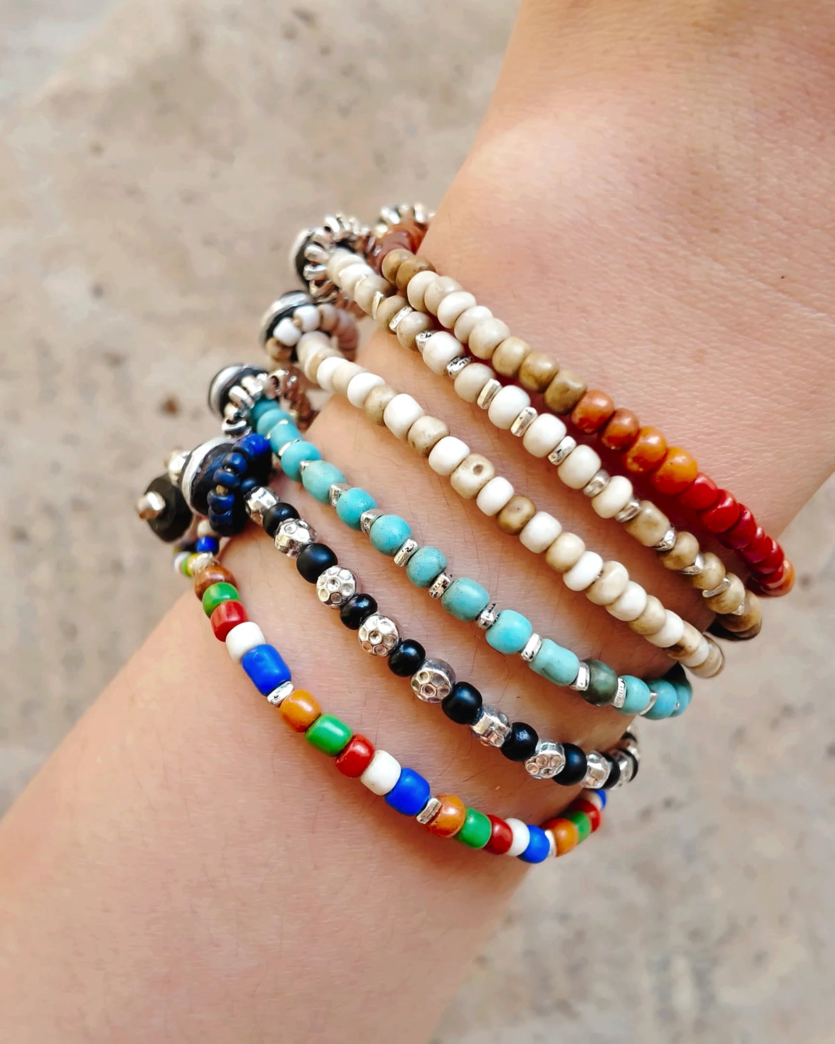 Close worn view of all six Daybeads bracelet styles; each style is sold separately