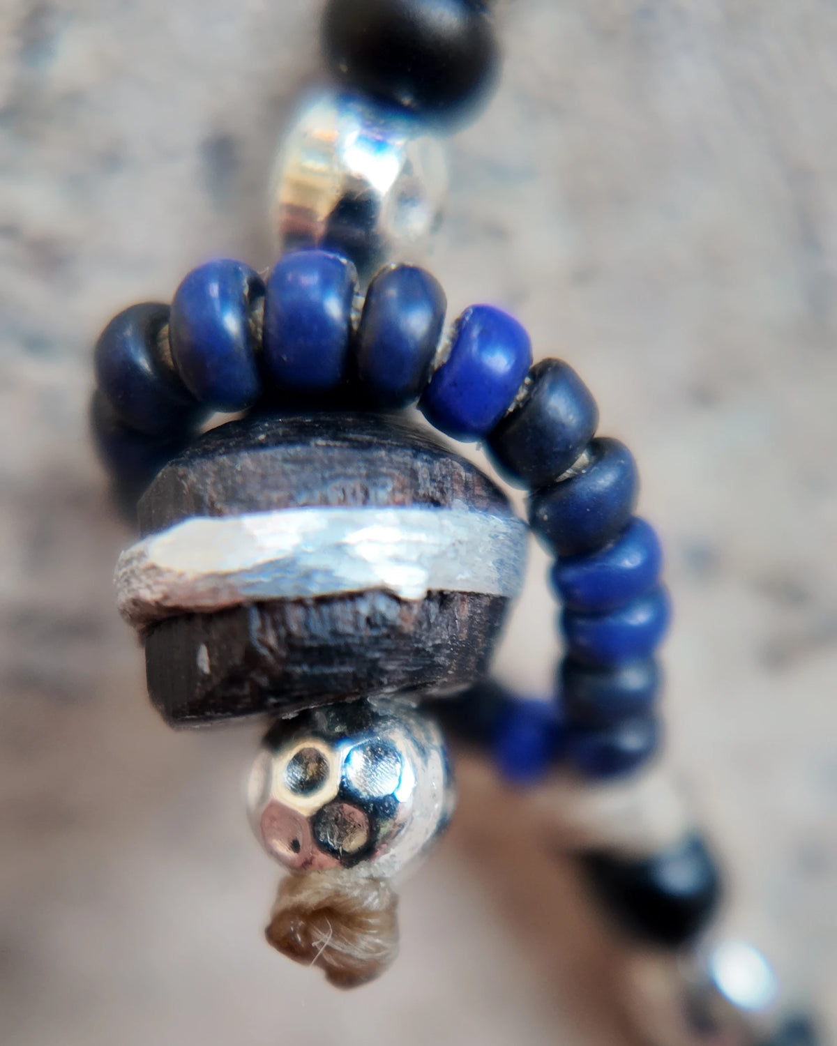 The Daybeads #46 Black & Silver bracelet ebony finishing bead, inlay and cord detail