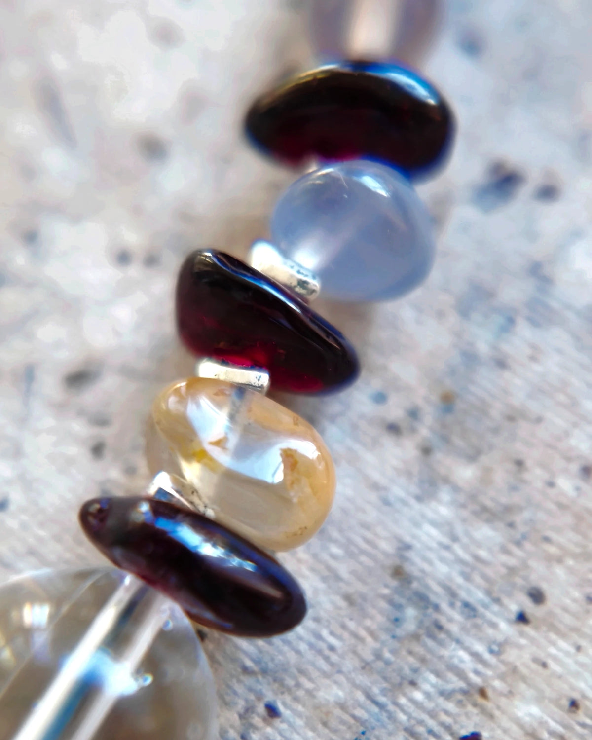 Pale agate beads between dark burgundy garnet chips and silver-coloured spacers