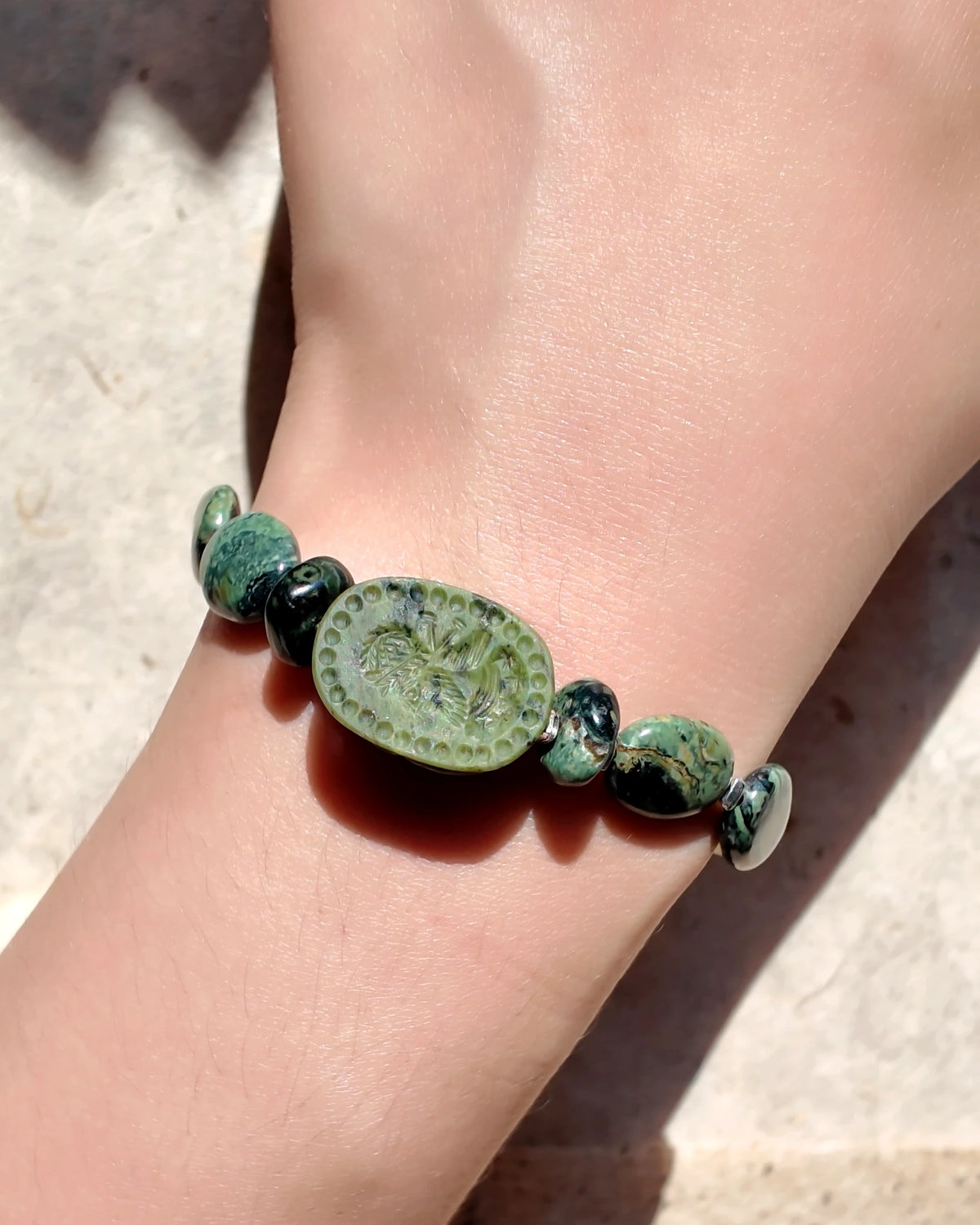 The Greenkeeper #58: Carved front of the scarab focal worn on wrist