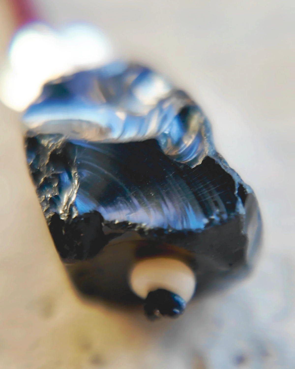 The Nightglass #53: Black obsidian fracture ridges with reflective highlights
