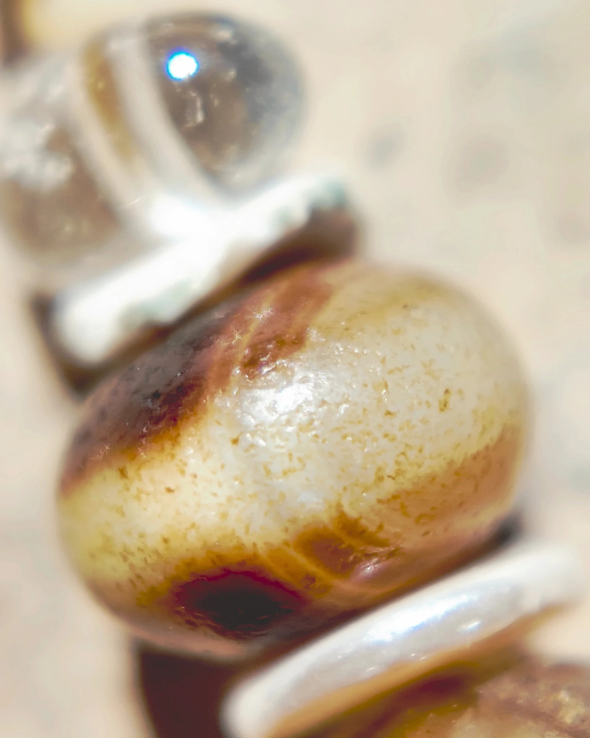 The Stillwater #55: Brown-and-cream Tibetan Medicine Buddha agate bead between shell spacers