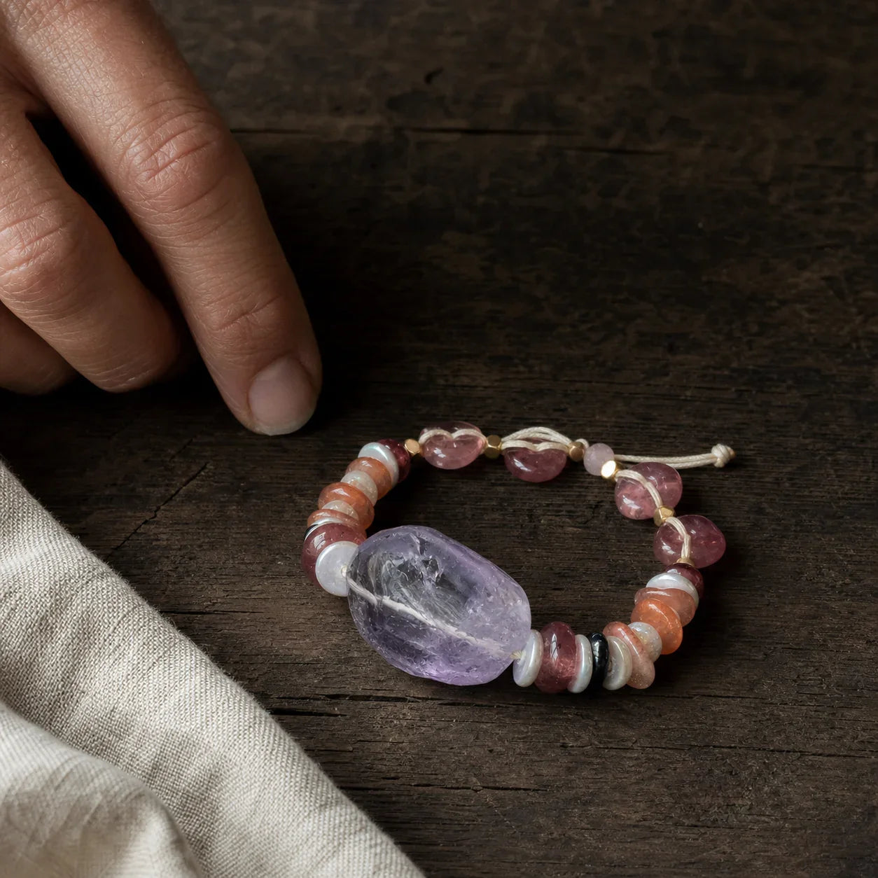 Amethyst quartz mindfulness bracelet on a walnut workbench
