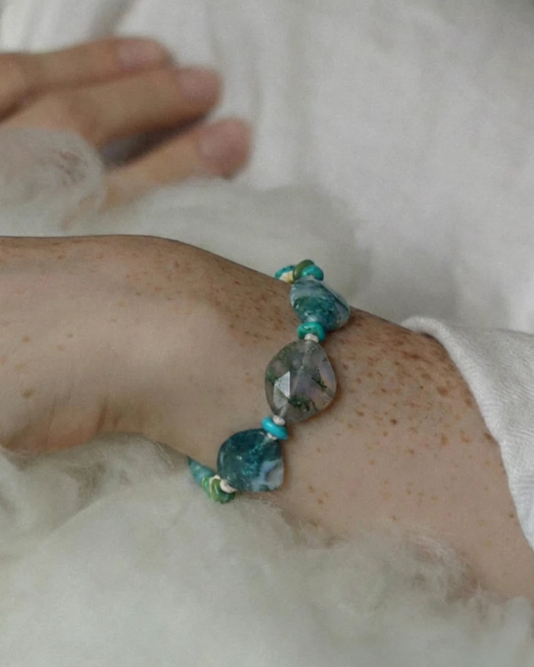 The Cultivator #18 moss agate abundance bracelet by à la luck — worn on the wrist showing faceted moss agate and turquoise nuggets in scale