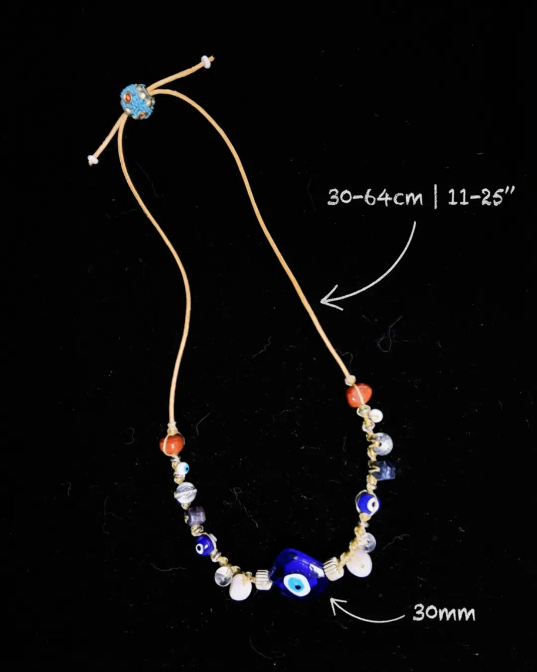 Closure detail of The Seer #19 — labelled oxidized brass beaded bead, leather cord, and Himalayan glass bead at the adjustable slip-knot