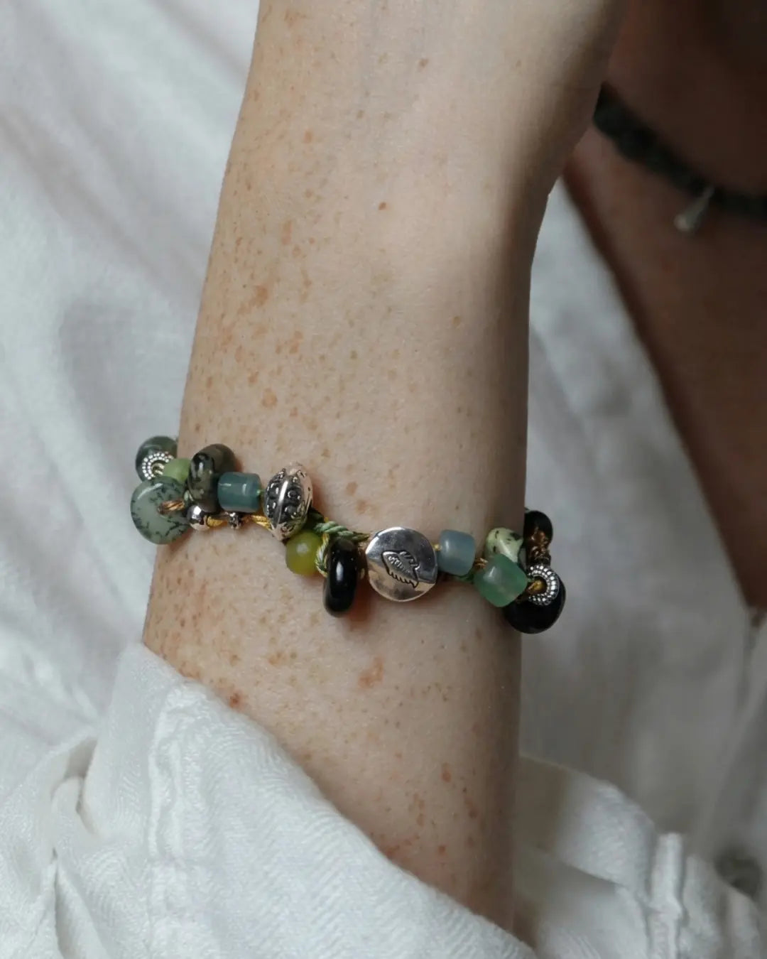 The Earthbound #20 rainforest jasper grounding bracelet by à la luck — worn on the wrist showing the cluster of jasper, glass, and Tibetan-style alloy beads