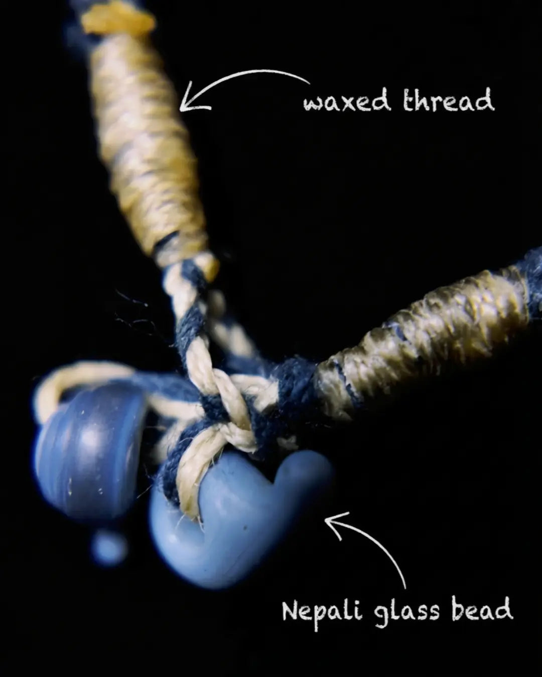 Closure detail of The Visionary #21 — labelled waxed thread and Nepali glass beads at the slip-knot loop