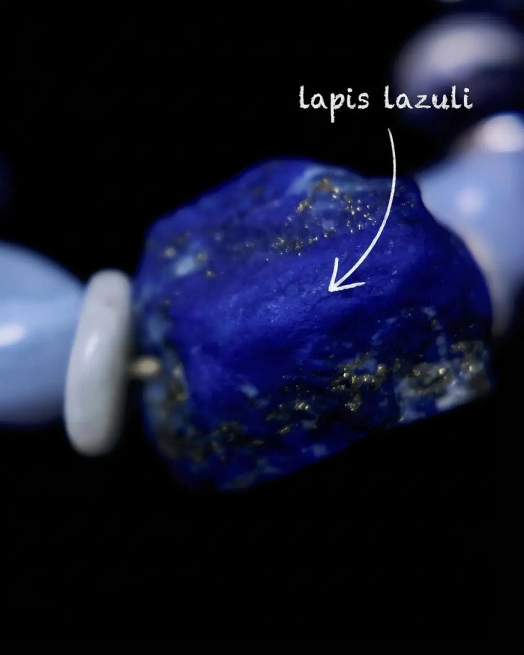 Raw lapis lazuli macro from The Visionary #21 — labelled close-up of the unpolished face with pyrite gold flecks