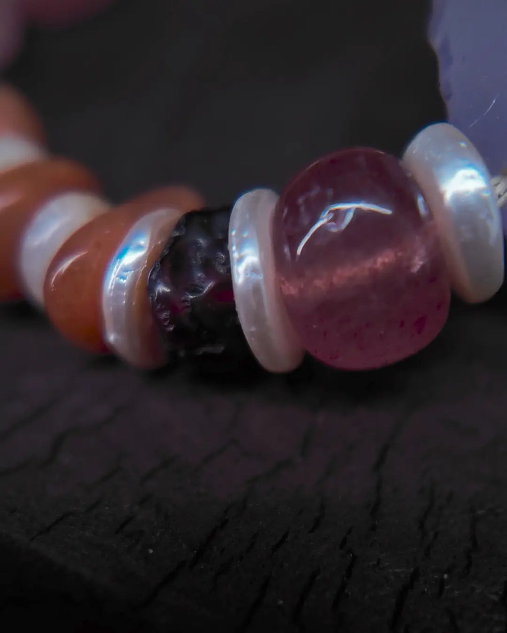 Strawberry quartz and mother-of-pearl spacer side detail showing bead-knot construction