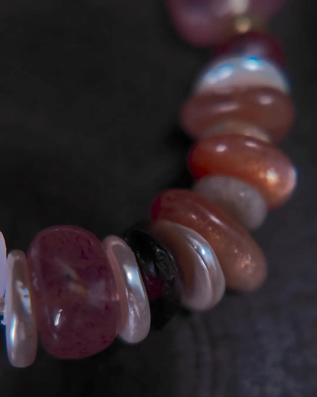 The Mystic #23 amethyst quartz bracelet, top-down full view on dark wood surface