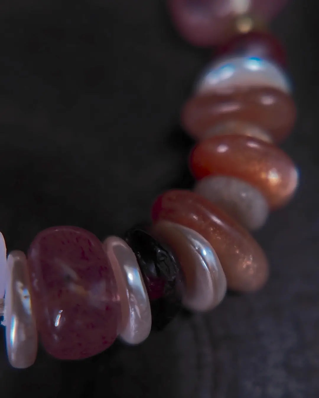 The Mystic #23 amethyst quartz bracelet, top-down full view on dark wood surface
