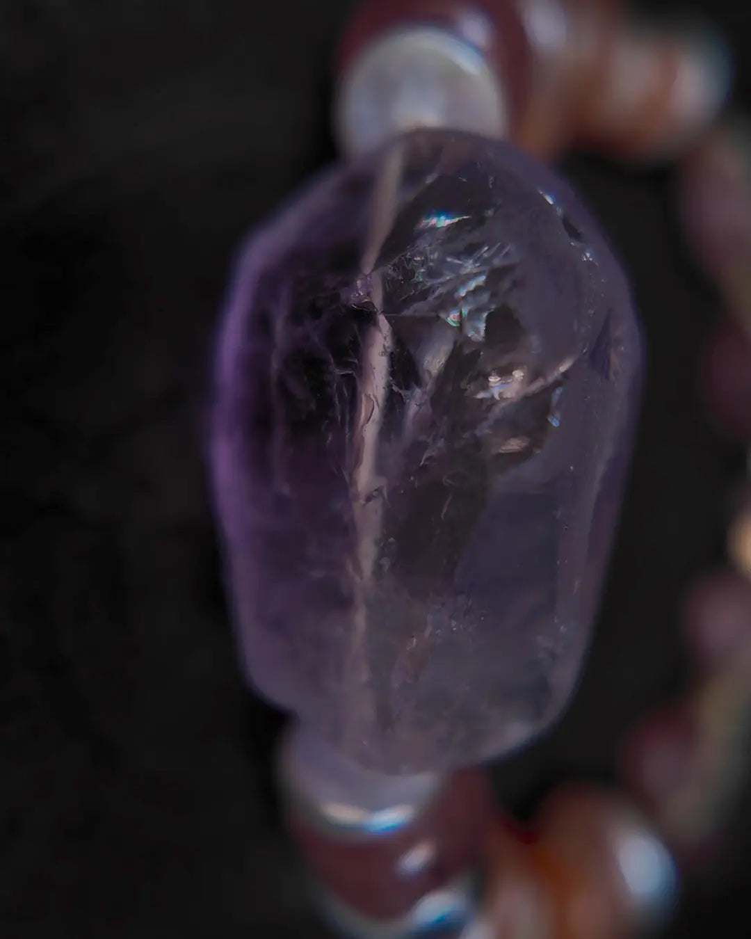 Polished amethyst quartz focal stone side-profile detail showing translucent natural form
