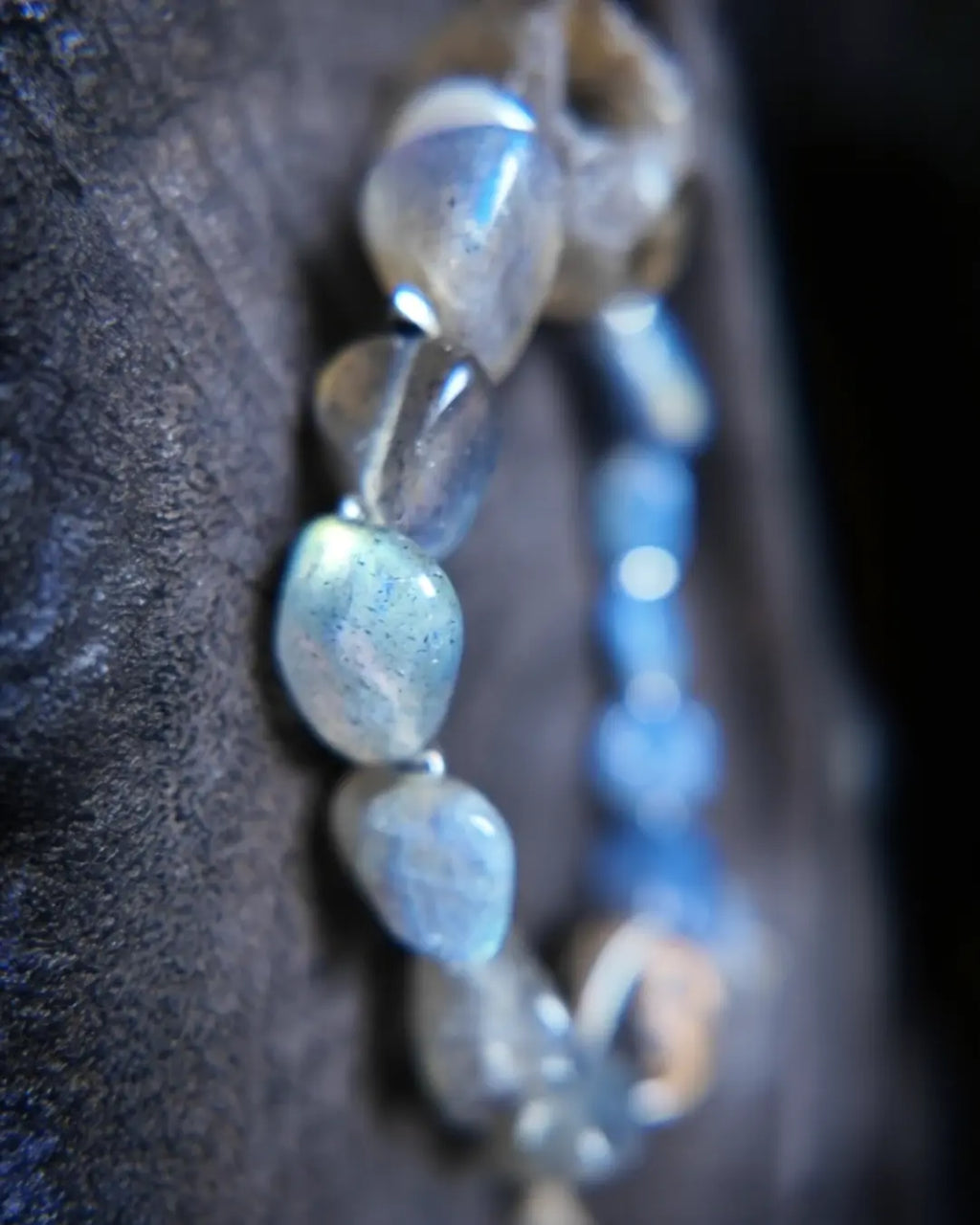 Side stack of labradorite tumbled stones with blue labradorescence flash and Himalayan blue kyanite accent stones