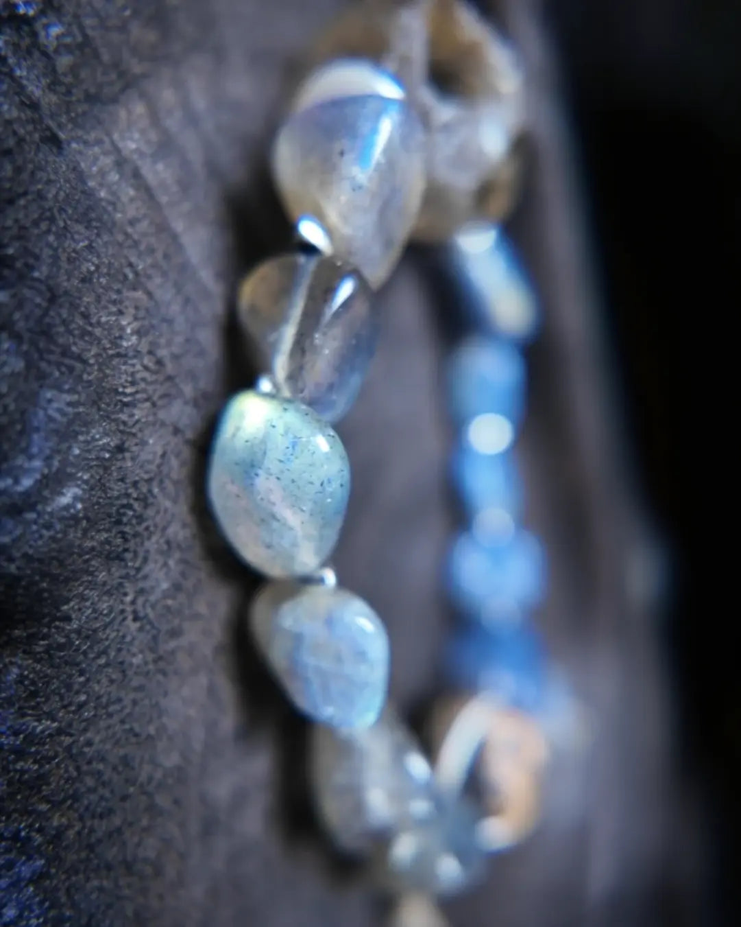 Side stack of labradorite tumbled stones with blue labradorescence flash and Himalayan blue kyanite accent stones