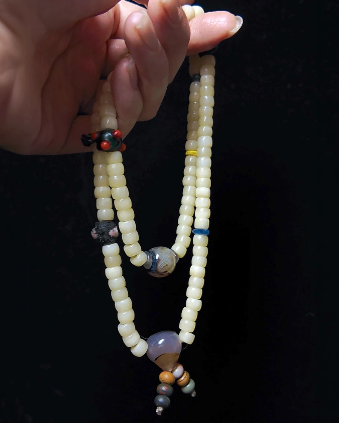 The Veil #28 necklace, hero lifestyle shot featuring banded agate, approx 13.5mm