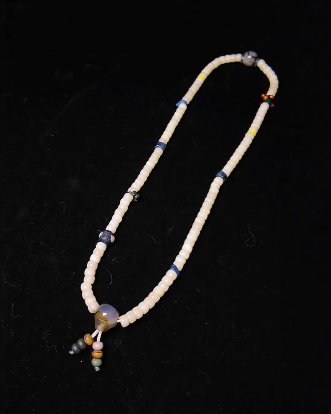 The Veil #28 necklace, detail view 4 — showing bead-knot construction and accent stones