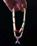 The Spark #29 necklace, hero lifestyle shot featuring bamboo coral, approx 16mm