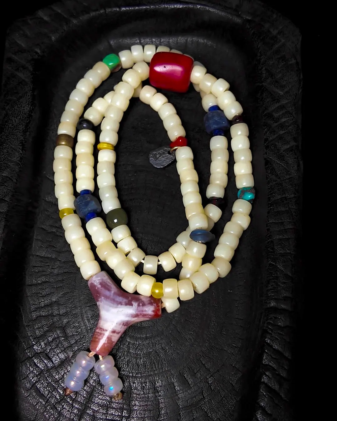 The Spark #29 necklace, detail view 5 — showing bead-knot construction and accent stones
