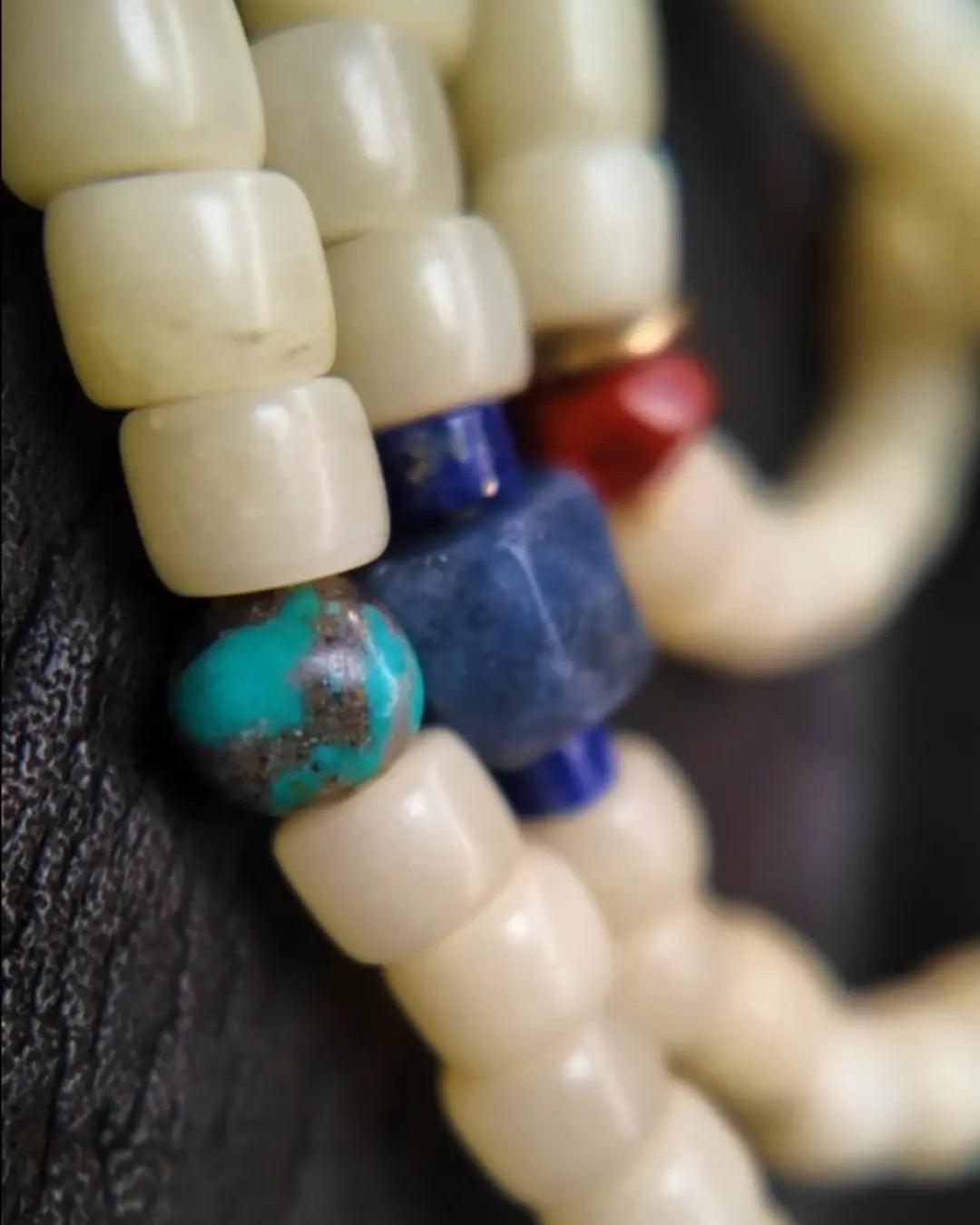 Macro of turquoise and blue square accent beads among camel bone beads in The Spark #29