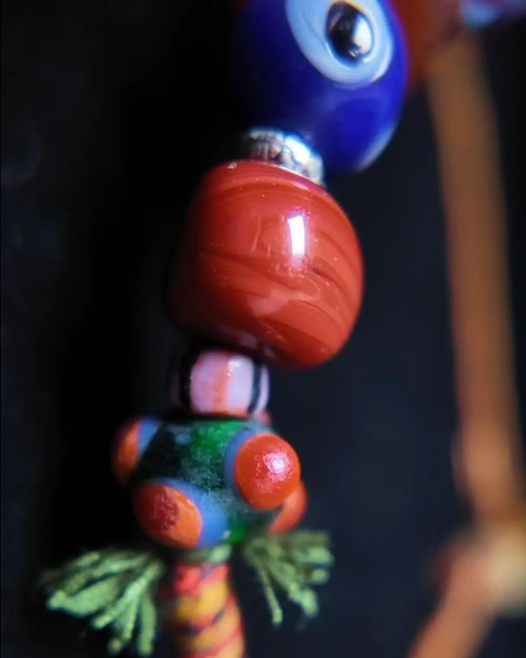 The Aegis #30 dragonfly eye protection necklace, detail view 6 — showing evil eye glass, patina red agate, and Tibetan silver accents