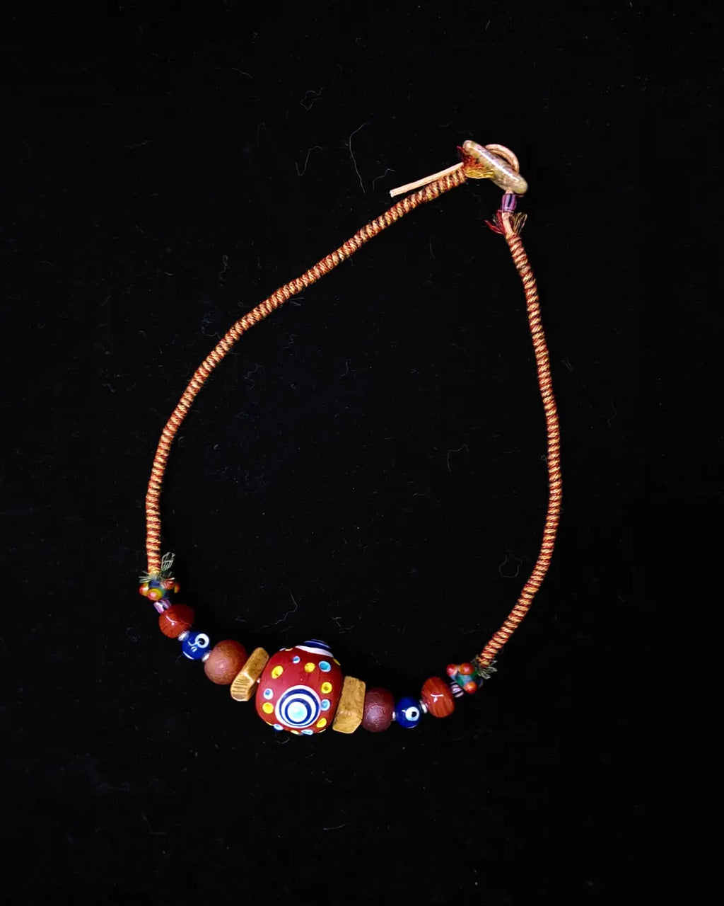 The Aegis #30 dragonfly eye protection necklace, closure detail showing unakite toggle and sliding-knot finish