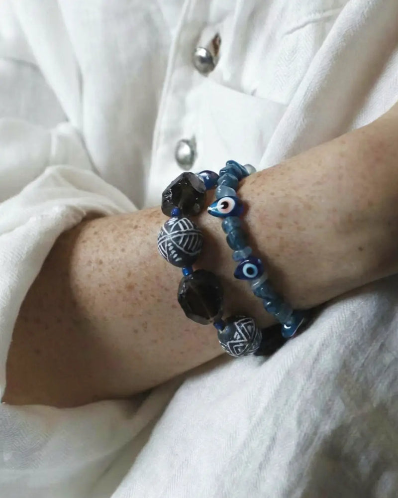 Smoky quartz and Mali clay bracelet worn at the wrist