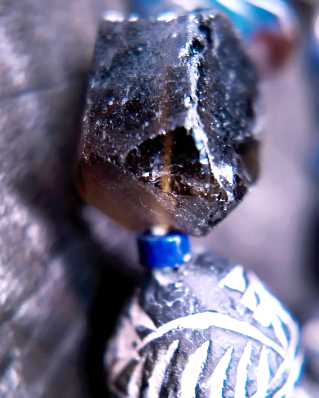 Macro detail of carved African Mali clay bead and Himalayan old-mine smoky quartz nugget focal