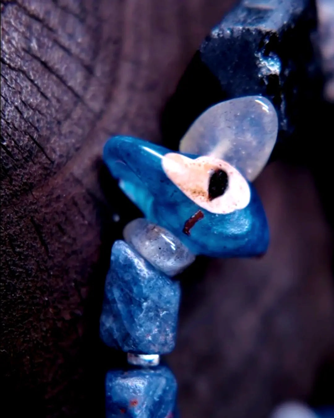 The Ancestor #31 smoky quartz and Mali clay grounding bracelet, detail view 4 — showing lapis lazuli, labradorite, raw sapphire, and evil eye glass accents
