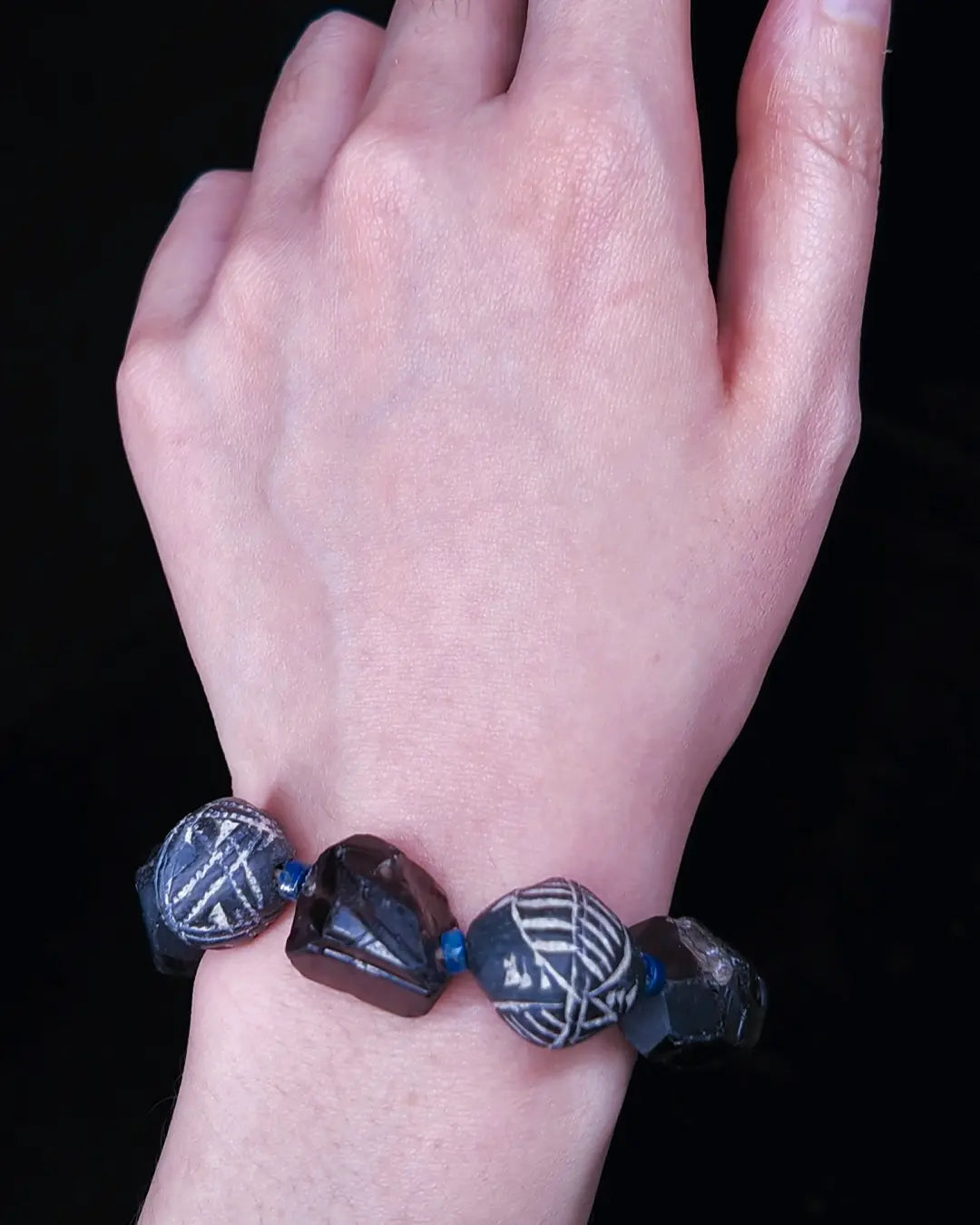 The Ancestor #31 smoky quartz and Mali clay grounding bracelet, detail view 5 — showing lapis lazuli, labradorite, raw sapphire, and evil eye glass accents