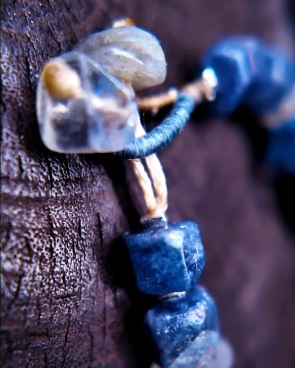 The Ancestor #31 smoky quartz and Mali clay grounding bracelet, detail view 6 — showing lapis lazuli, labradorite, raw sapphire, and evil eye glass accents