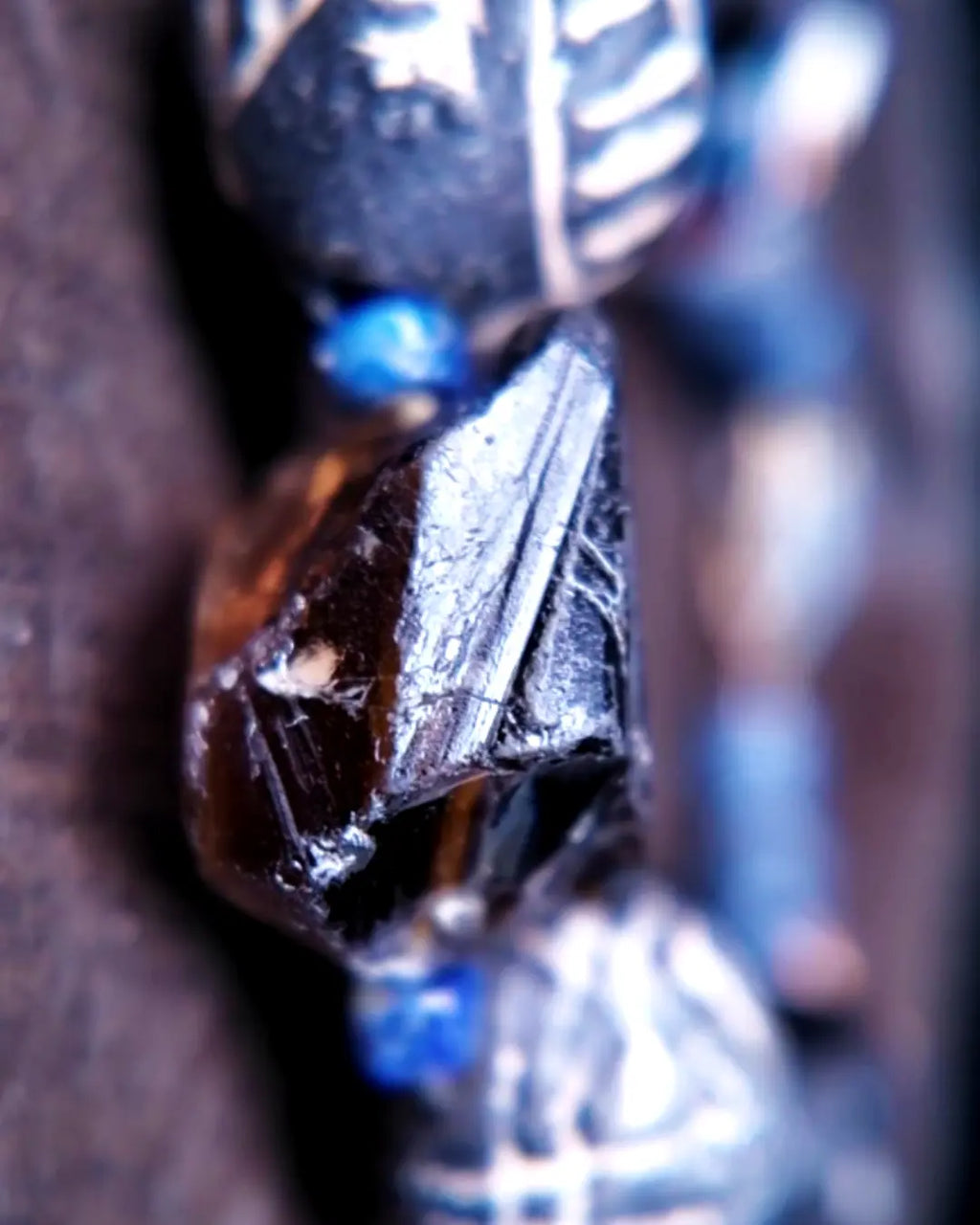 The Ancestor #31 smoky quartz and Mali clay grounding bracelet, detail view 7 — showing lapis lazuli, labradorite, raw sapphire, and evil eye glass accents