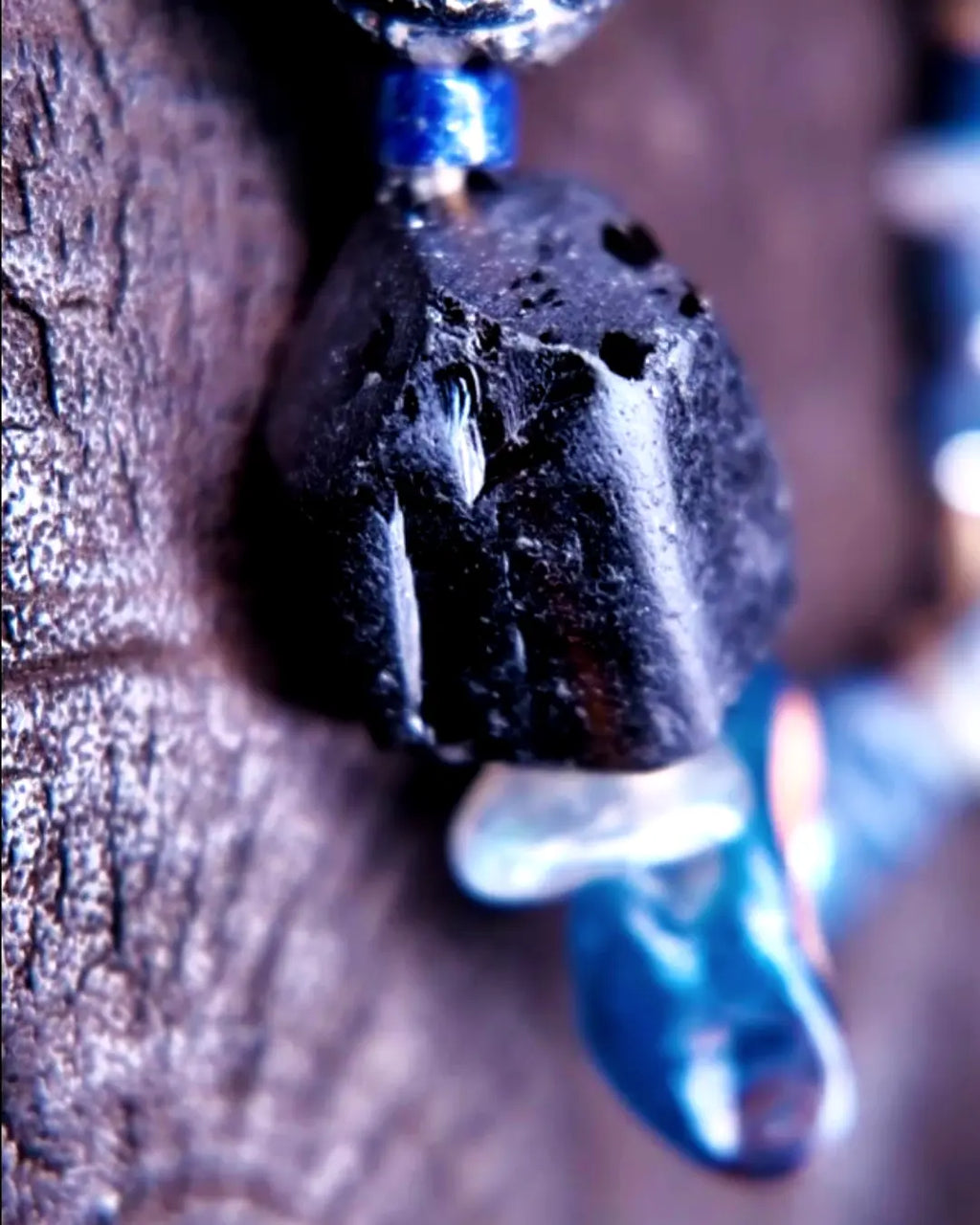 The Ancestor #31 smoky quartz and Mali clay grounding bracelet, detail view 8 — showing lapis lazuli, labradorite, raw sapphire, and evil eye glass accents