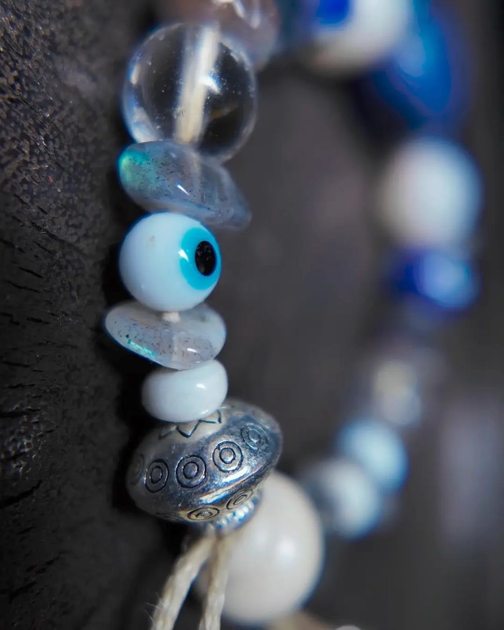 The Augur #33 lapis lazuli and blue moonstone vision bracelet, detail view 7 — showing raw sapphire, labradorite, clear quartz, and evil eye glass accents