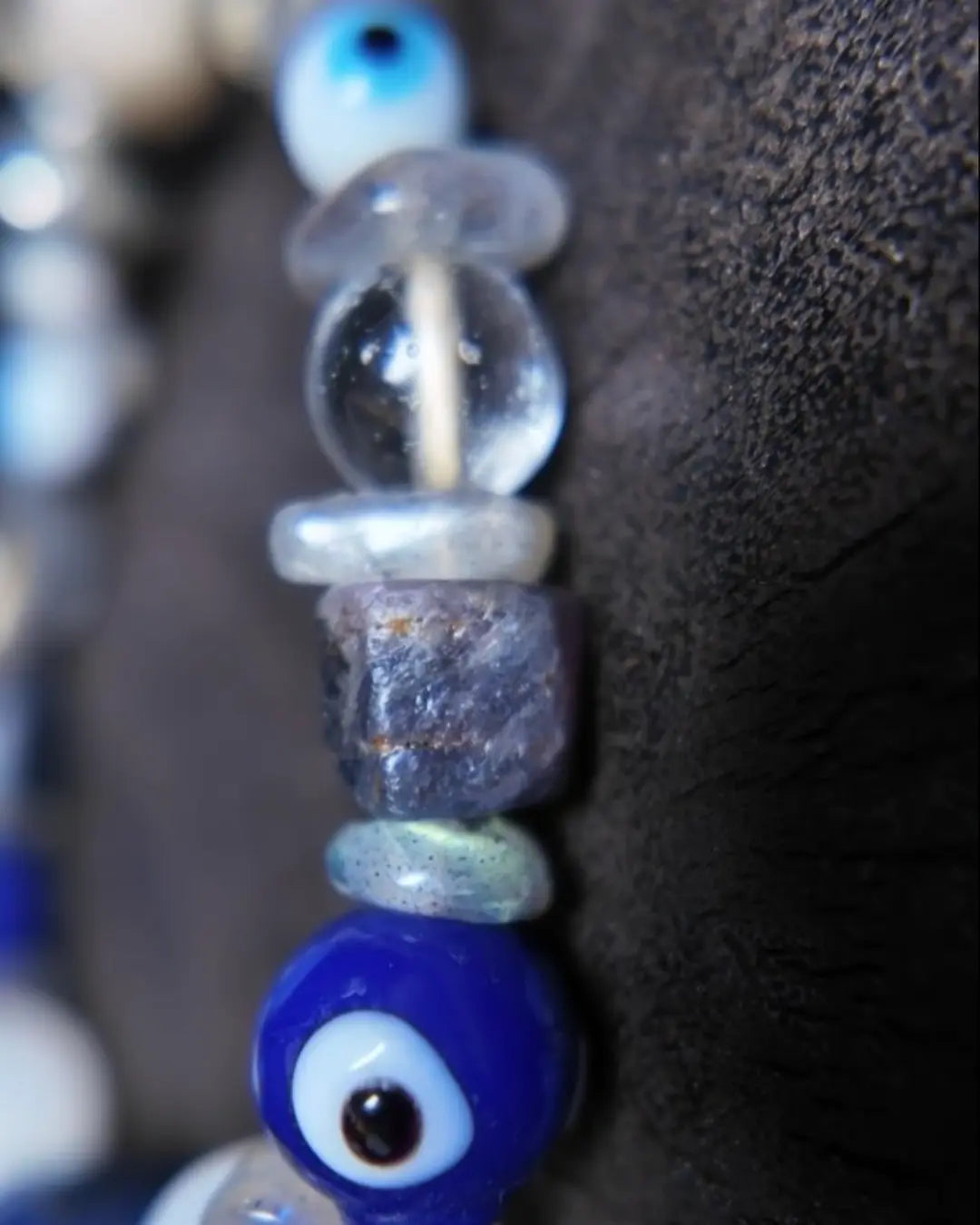 The Augur #33 lapis lazuli and blue moonstone vision bracelet, detail view 8 — showing raw sapphire, labradorite, clear quartz, and evil eye glass accents