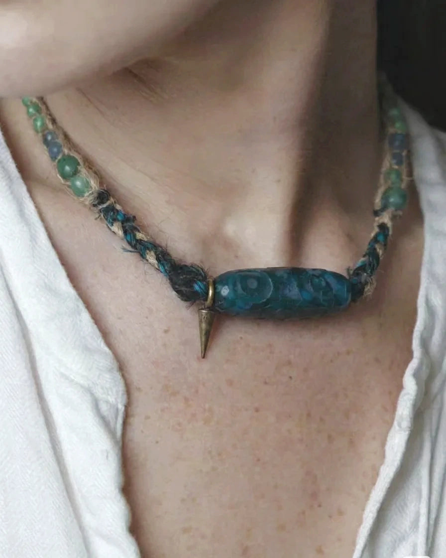 The Axis #39 moss agate Dzi-form hemp choker worn close at the neck