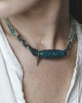 The Axis #39 moss agate Dzi-form hemp choker worn close at the neck
