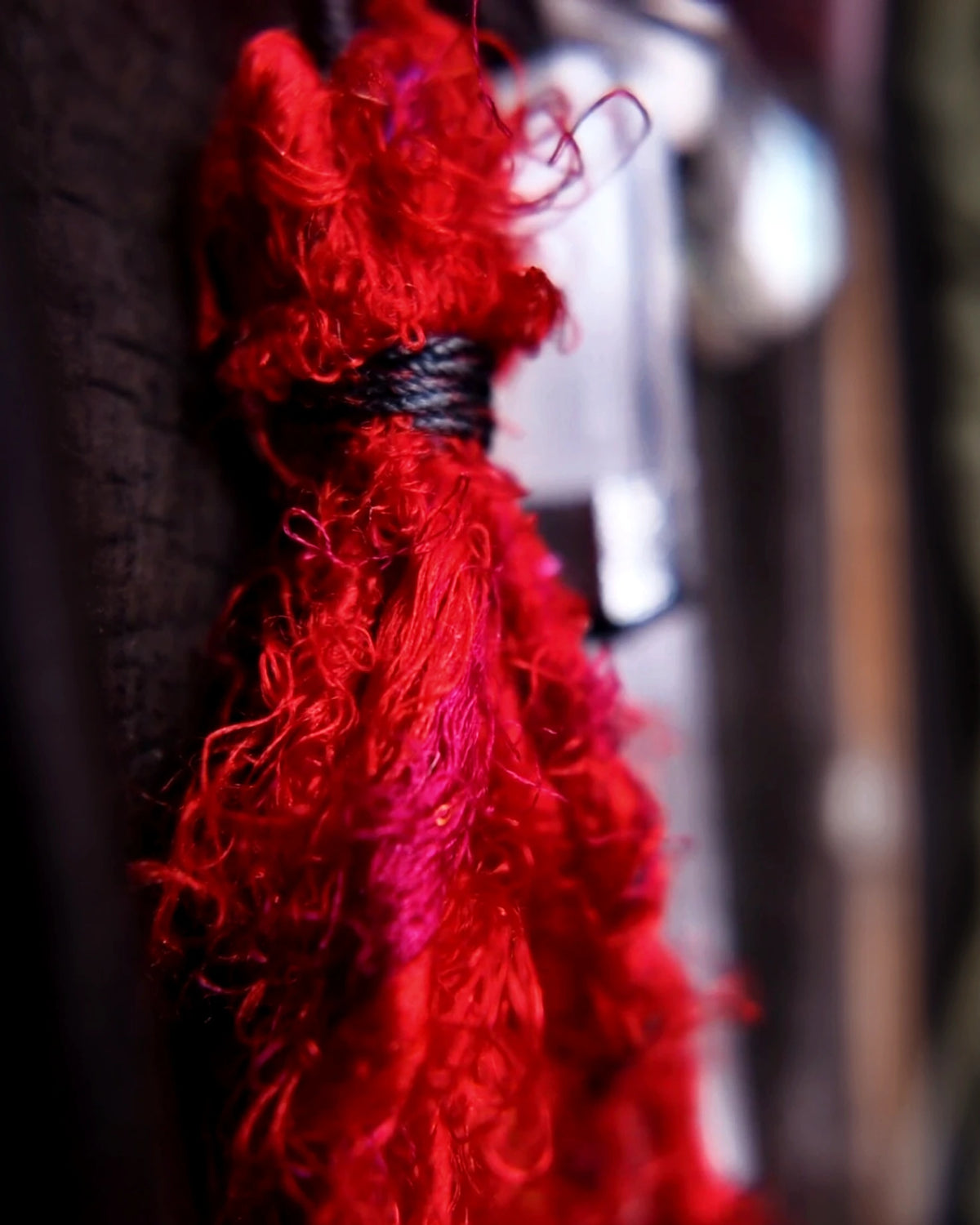 Close view of the hand-spun red Nepali banana-silk yarn tassel
