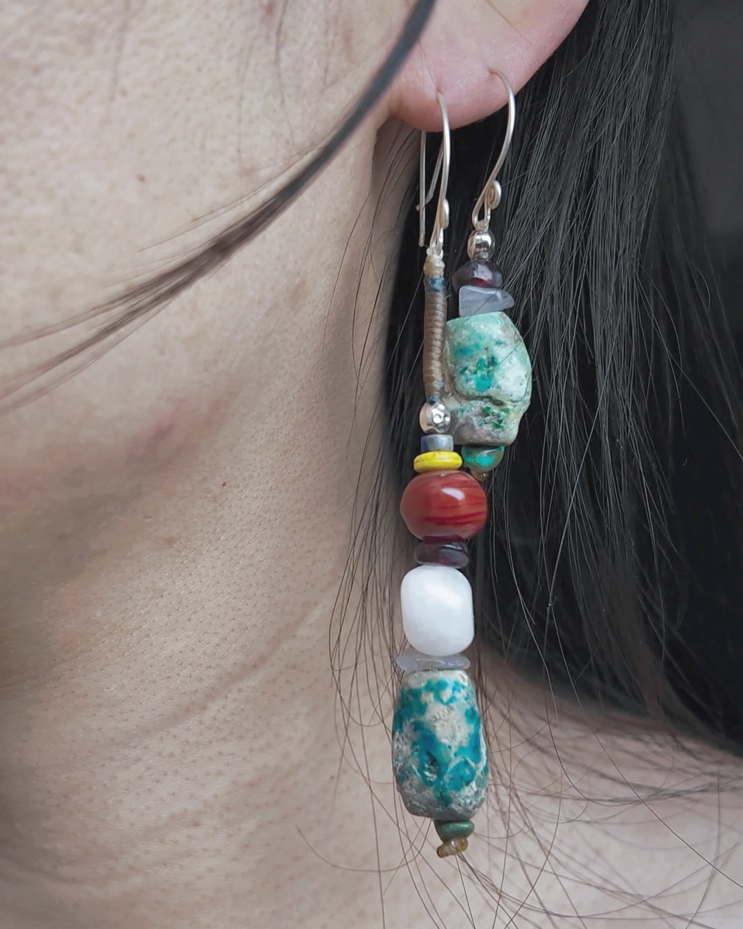The Counterpoint #38 asymmetric raw turquoise earrings worn as a deliberate short-and-long pair