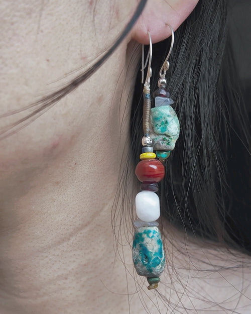 The Counterpoint #38 asymmetric raw turquoise earrings worn as a deliberate short-and-long pair