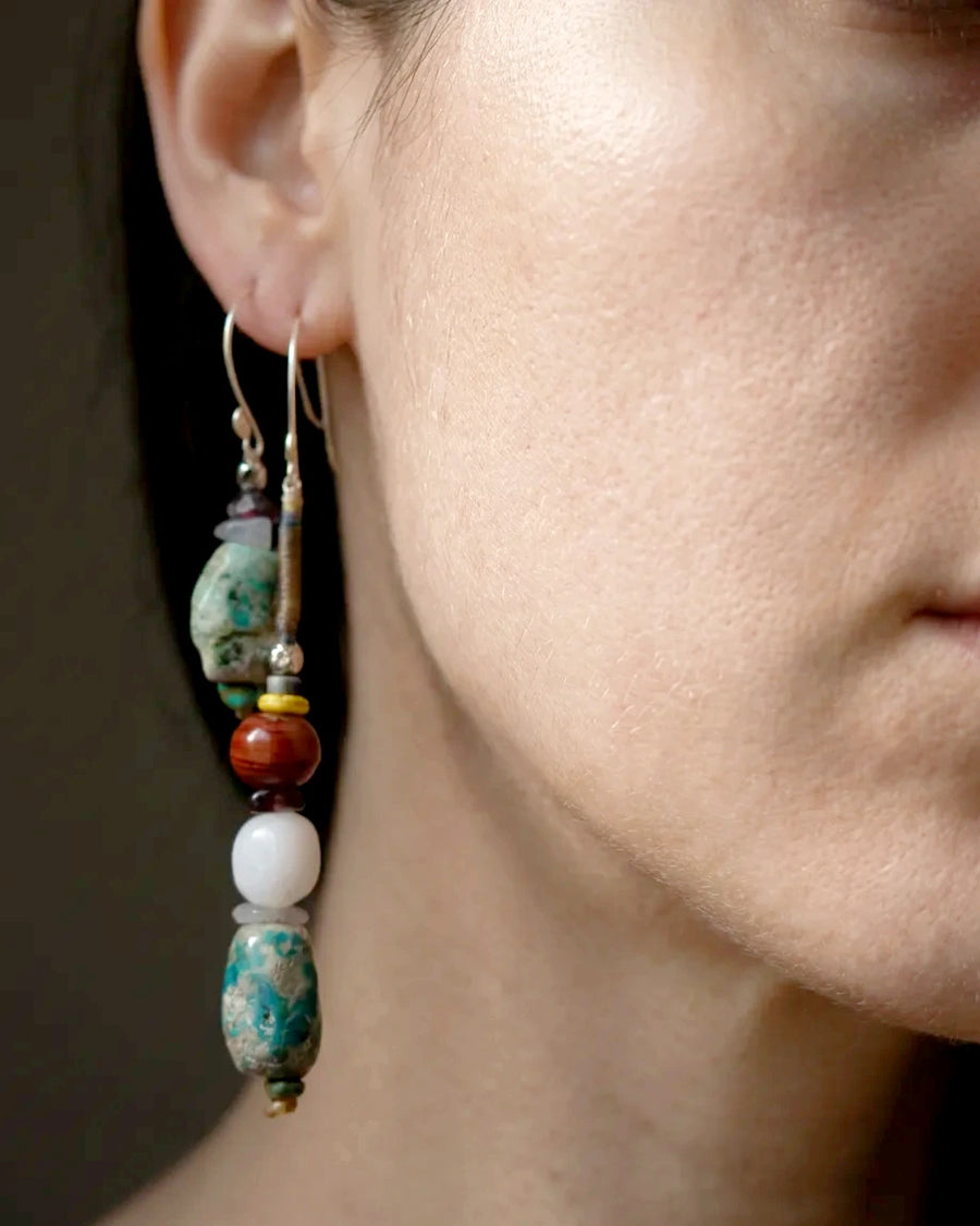 The Counterpoint #38 asymmetric raw turquoise earrings worn as a deliberate short-and-long pair