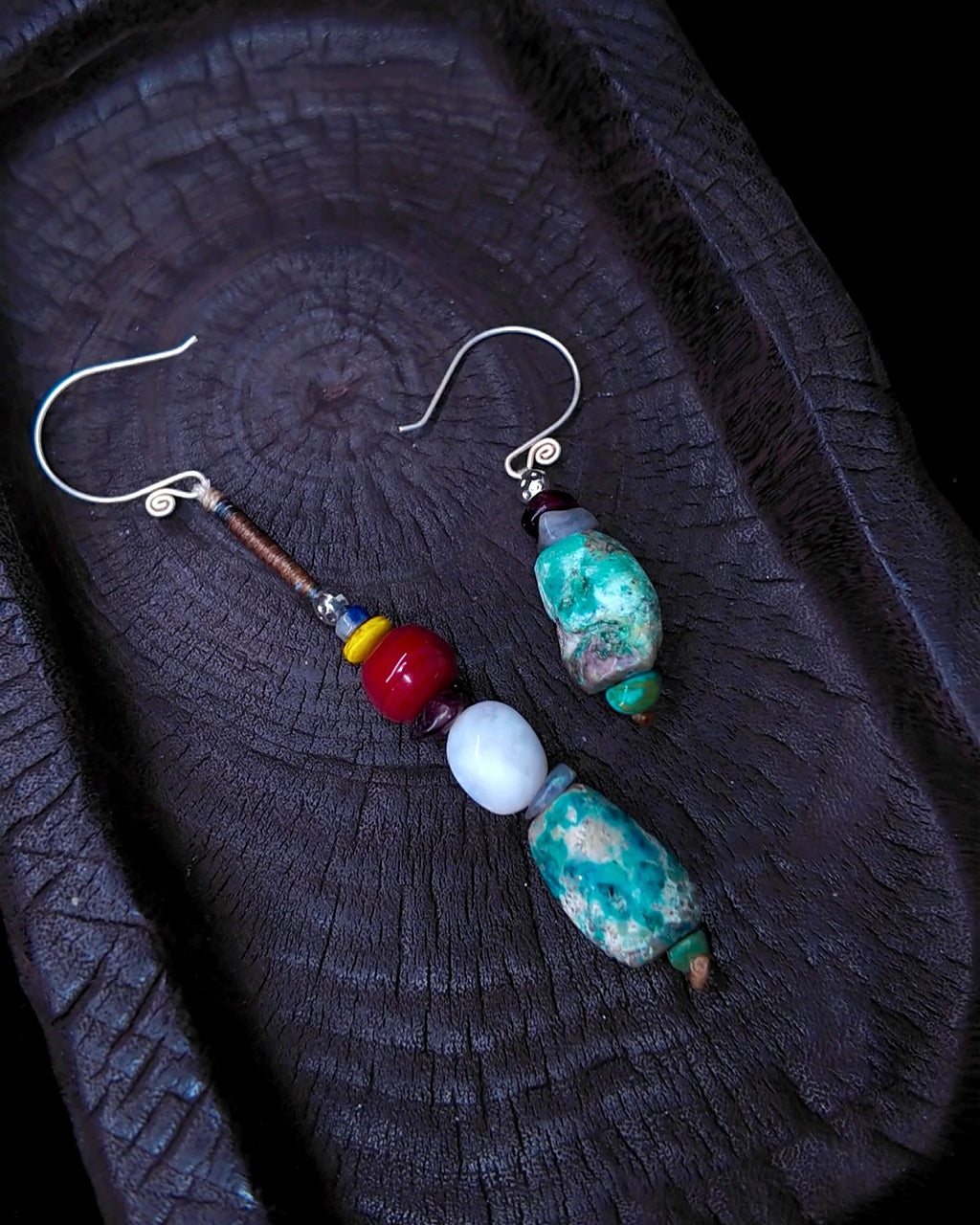 Full asymmetric pair of The Counterpoint #38 earrings on charred wood