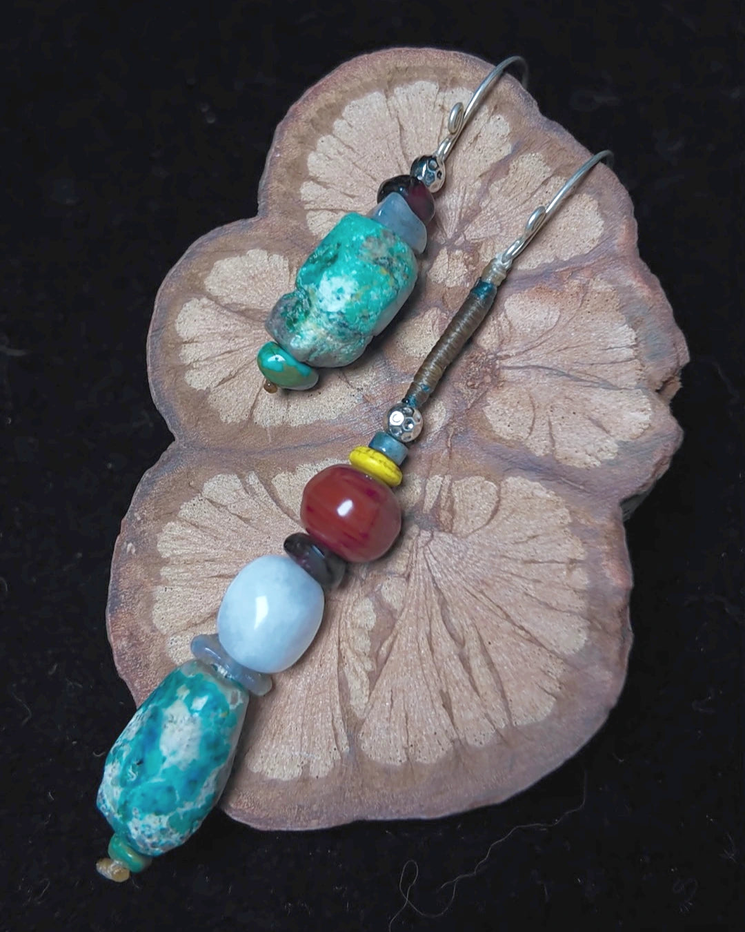 Full flat lay of The Counterpoint #38 raw turquoise drop earrings on dark wood