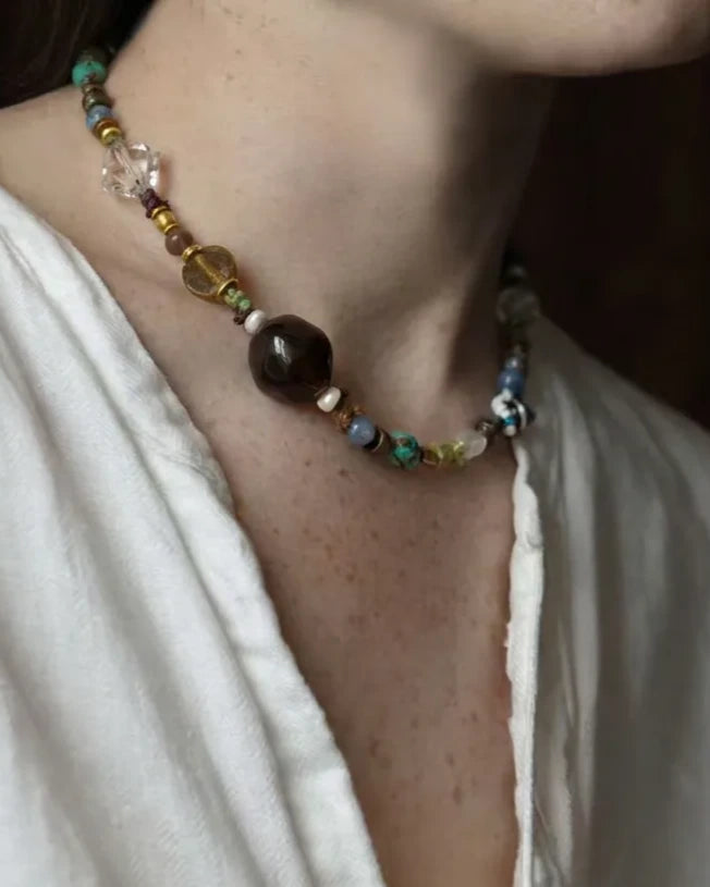 The Duet #48: Both Duet bracelets connected into a necklace, worn with an ivory linen shirt
