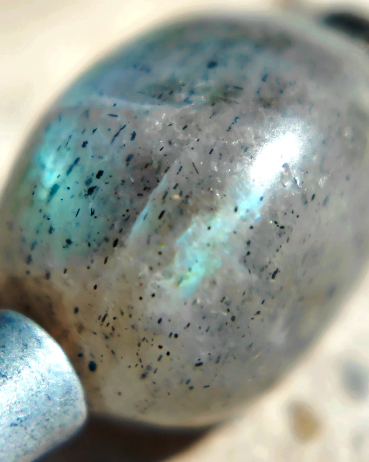 The Earthscript #57: Labradorite bead with reflected blue light