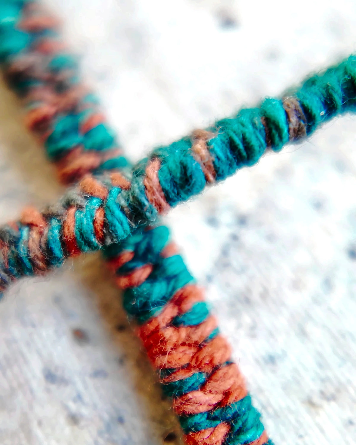 Teal and orange plant-dyed cotton wrapped around the waxed cord